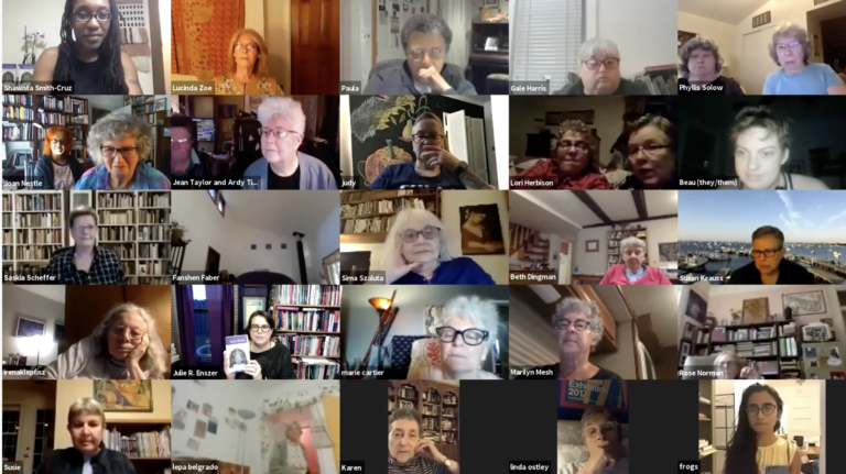 A screenshot from the live Zoom event celebrating the launch event for Sinister Wisdom volume 118, celebrating the Lesbian Herstory Archive's 45th Anniversary. In the image you can see a 5x5 grid of video images of people participating in the event. Each video image has one or two faces of people, some smiling, some looking on expectantly. One of the boxes features Julie Enszer holding up a copy of the issue of Sinister Wisdom as she addresses the virtual crowd.